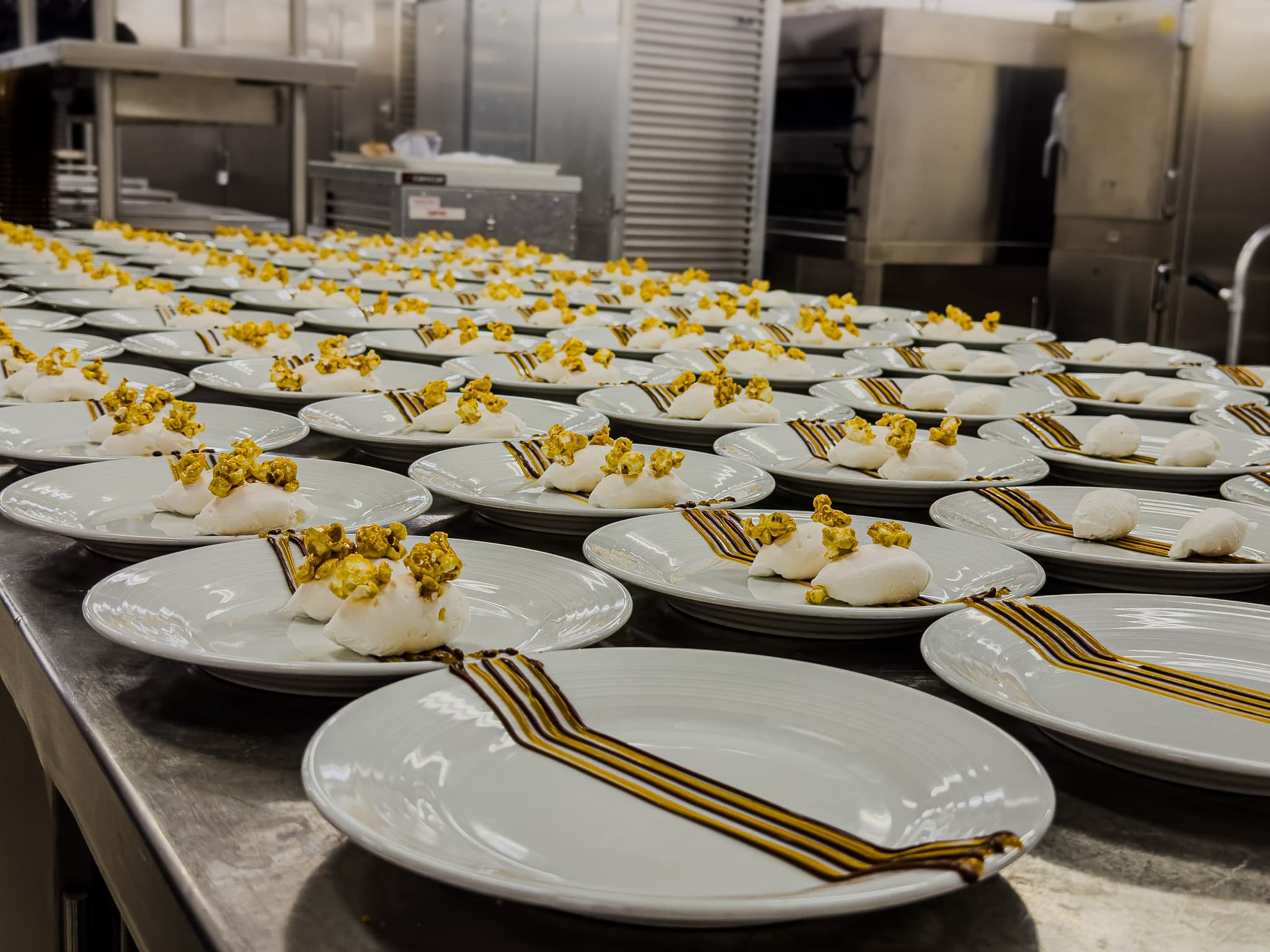Commercial food photography of plated dishes in a cruise kitchen