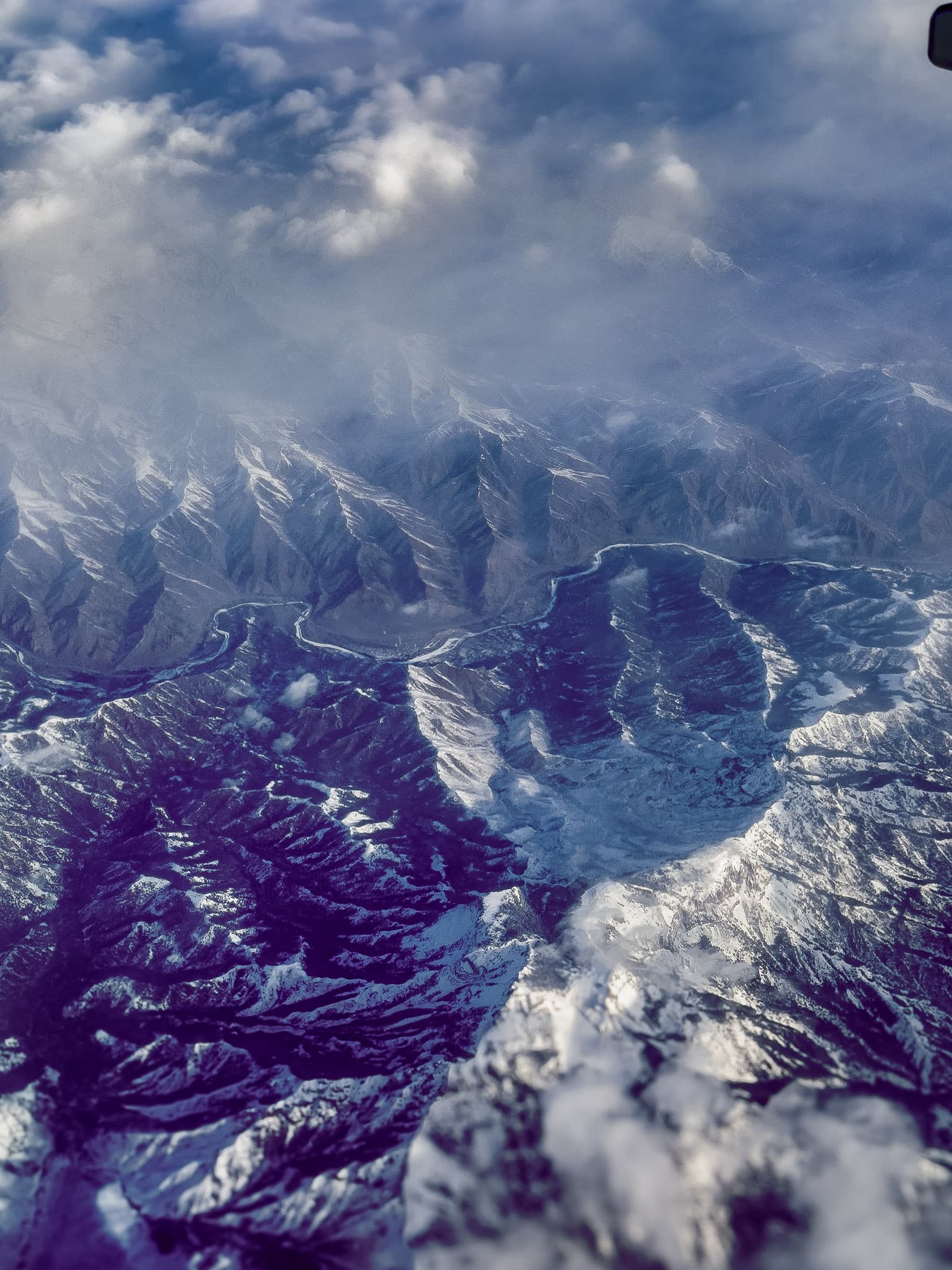Mountain peaks rising above a layer of low-lying clouds